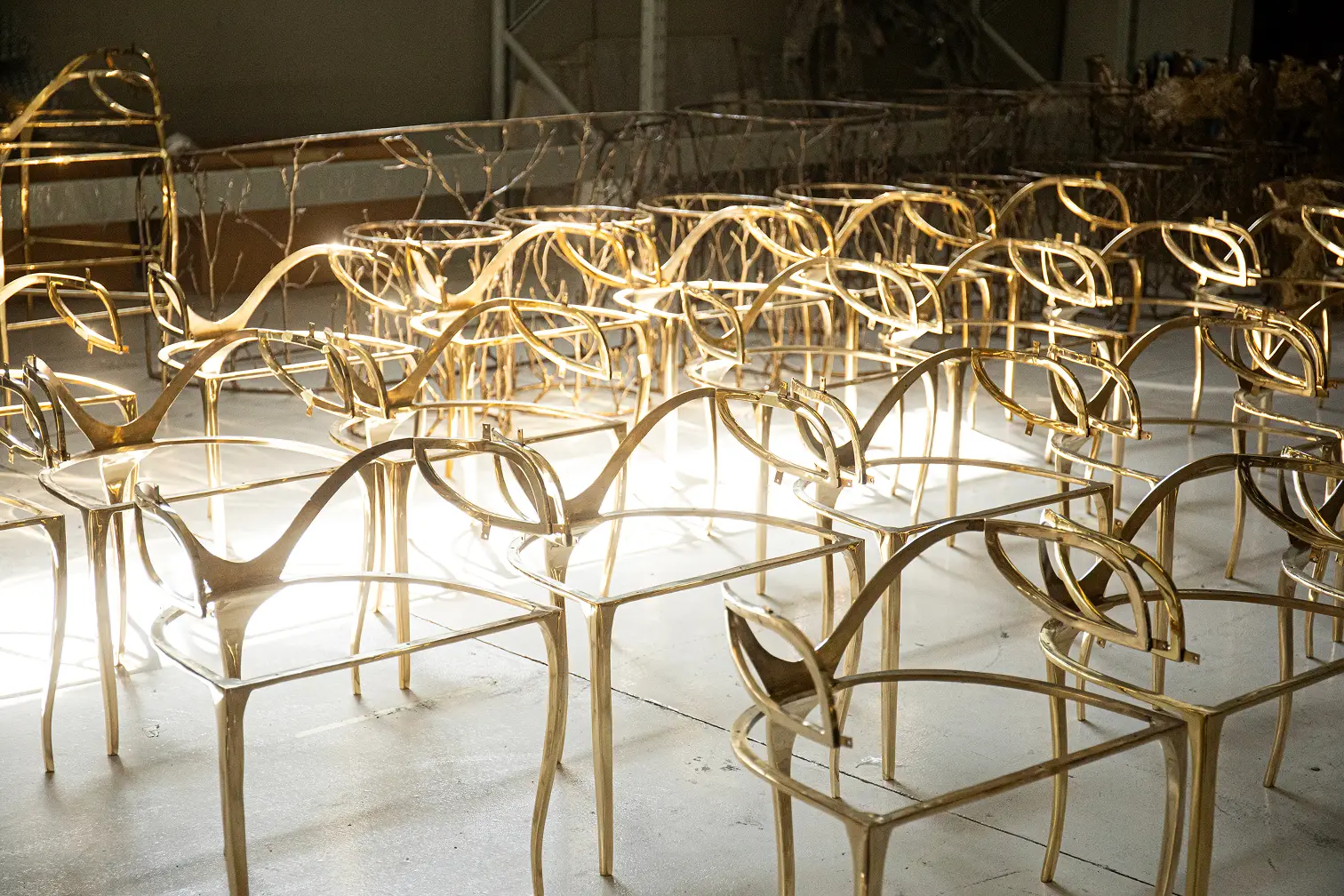 Golden metallic frames of Chandra Chairs, showcasing their unique design and construction.